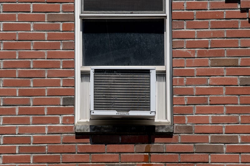An air conditioner is seen in a residential window on July 28, 2020, in New York City. 