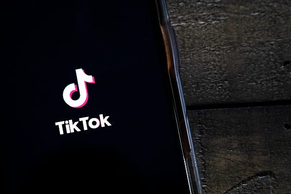 In this photo illustration, the TikTok app is displayed on an Apple iPhone on August 7, 2020 in Washington, DC. On Thursday evening, President Donald Trump signed an executive order that bans any transactions between the parent company of TikTok, ByteDance, and U.S. citizens due to national security reasons. The president signed a separate executive order banning transactions with China-based tech company Tencent, which owns the app WeChat. Both orders are set to take effect in 45 days. (Photo Illustration by Drew Angerer/Getty Images)