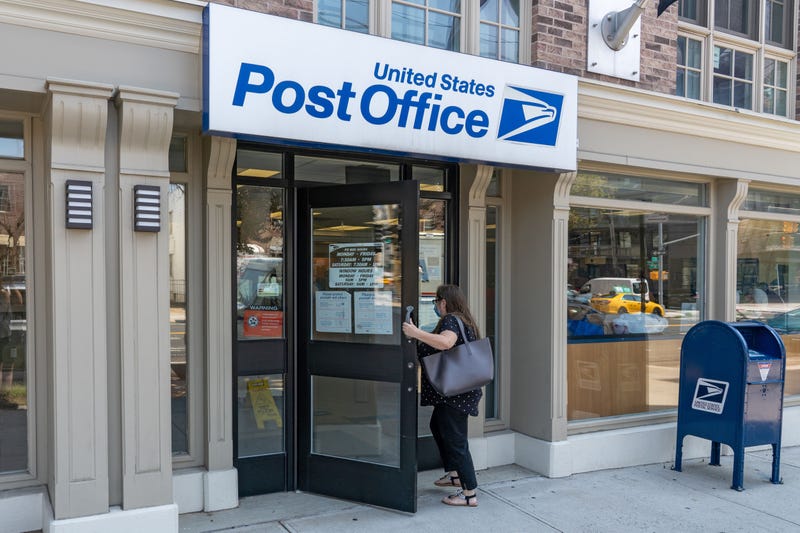 A woman enters a USPS location in Long Island City