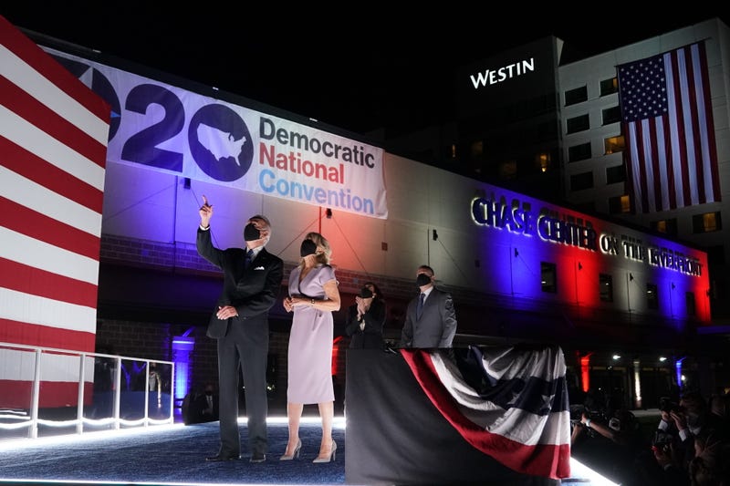 Joe Biden and wife Jill Biden, Senator Kamala Harris and husband Douglas Emhoff wear protective masks while looking at fireworks outside the Chase Center during the Democratic National Convention in Wilmington, Delaware, U.S., on Thursday, Aug. 20, 2020
