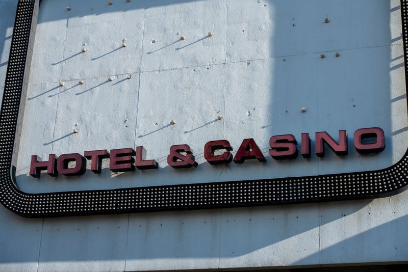 Afternoon light illuminates a sign stating 'HOTEL & CASINO' remaining on the exterior facade of Trump Plaza Hotel & Casino