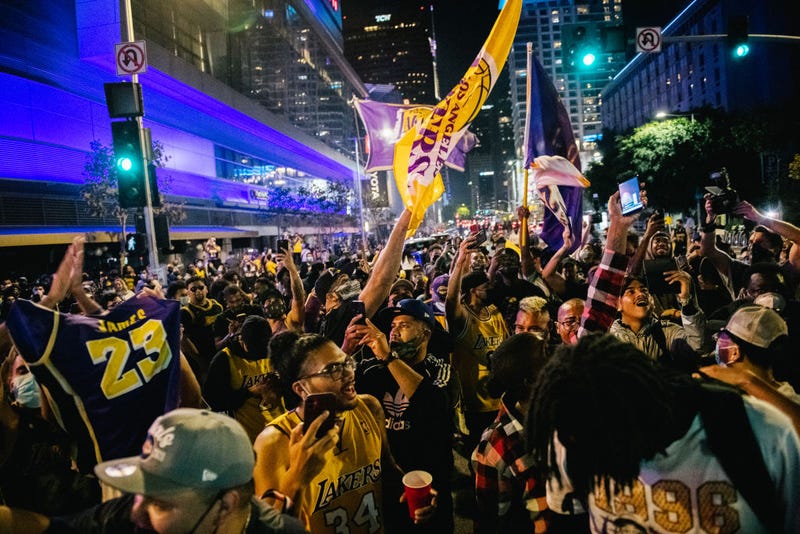 Lakers fans celebrate in front of the Staples Center on October 11, 2020 in Los Angeles, California.