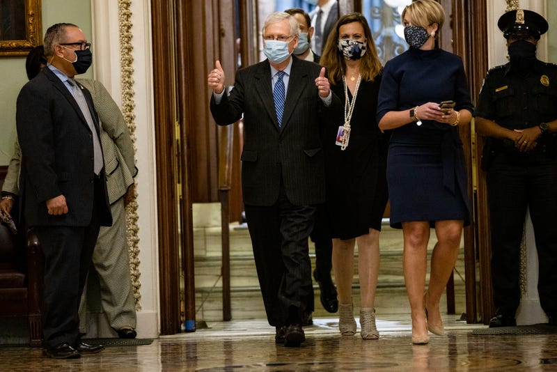 Senate Majority Leader Mitch McConnell (in light blue mask, center left), with soon-to-be Supreme Court Justice Amy Coney Barrett (middle))