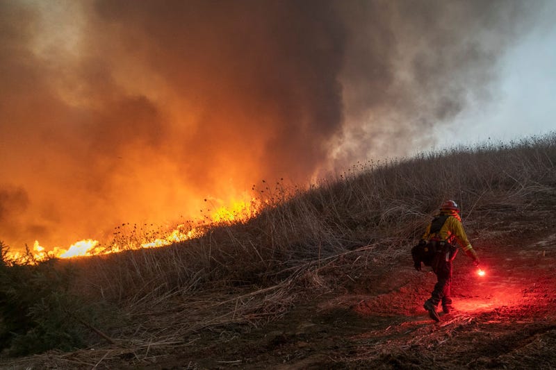 Firefighters set a backfire to protect homes and try to contain the Blue Ridge Fire on October 27, 2020 in Chino Hills, California.