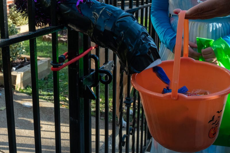 Children receive treats by candy chutes while trick-or-treating for Halloween in Woodlawn Heights on October 31, 2020 in New York City. 