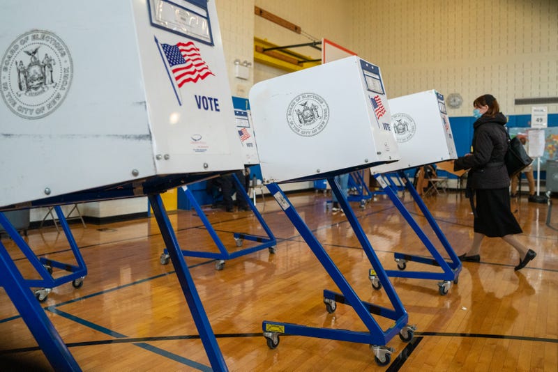A voter walks to a booth to fill out their ballot at a public school in Brooklyn