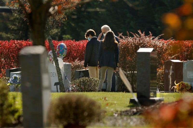 President-elect Joe Biden, center, salutes his son Beau Biden's grave after, attending church at St. Joseph on the Brandywine Roman Catholic Church in Wilmington, Delaware on Nov.8, 2020.