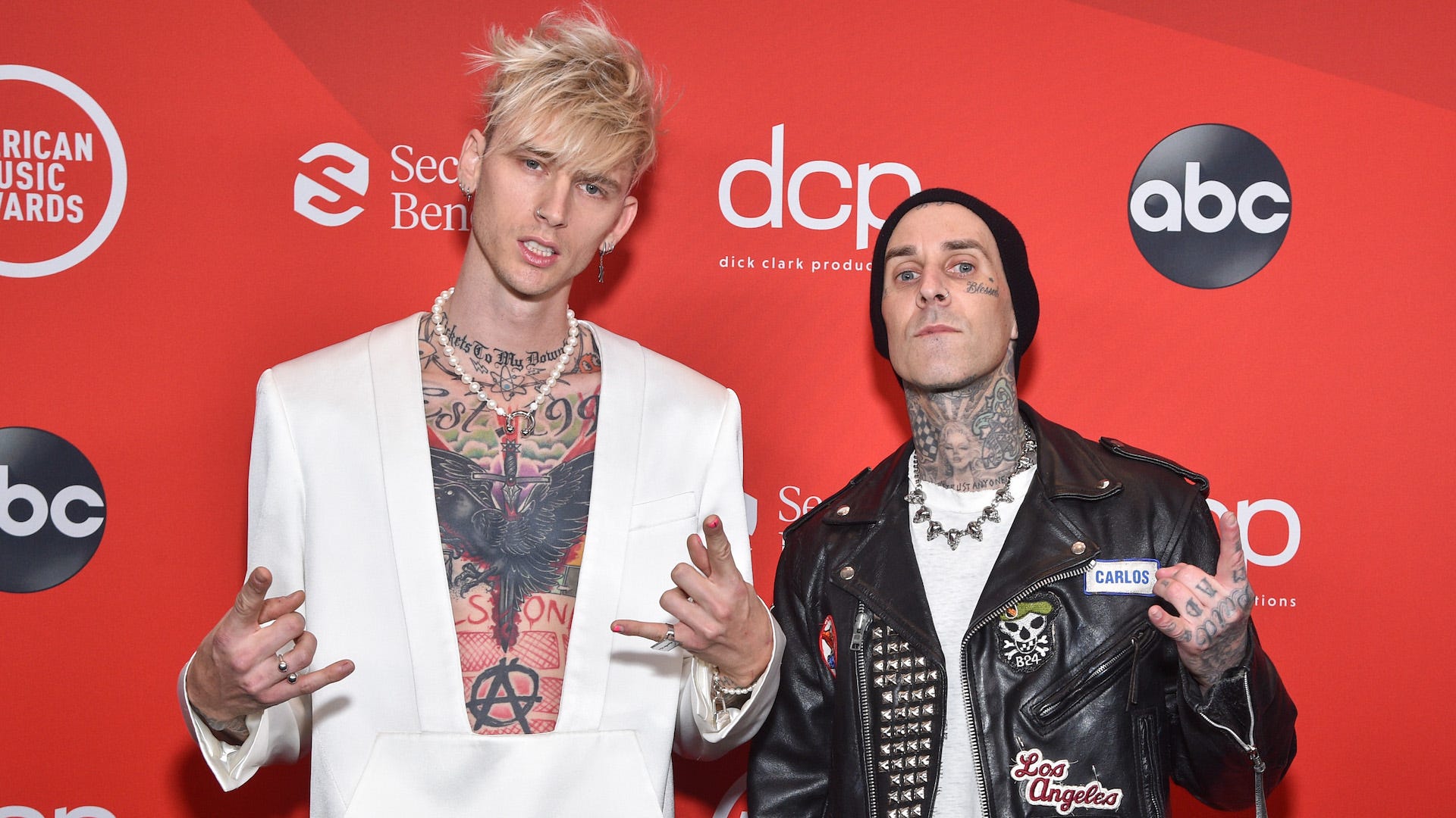 Watch Machine Gun Kelly tell Travis Barker he’s changing his album name, despite their matching tattoos