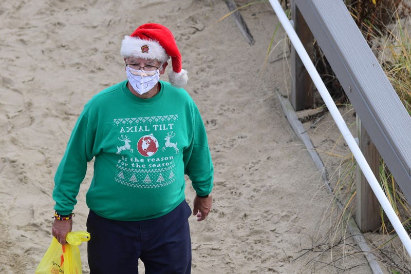 A man with a Santa Claus hat and beard face mask on November 27, 2020 in Rehoboth Beach, Delaware.