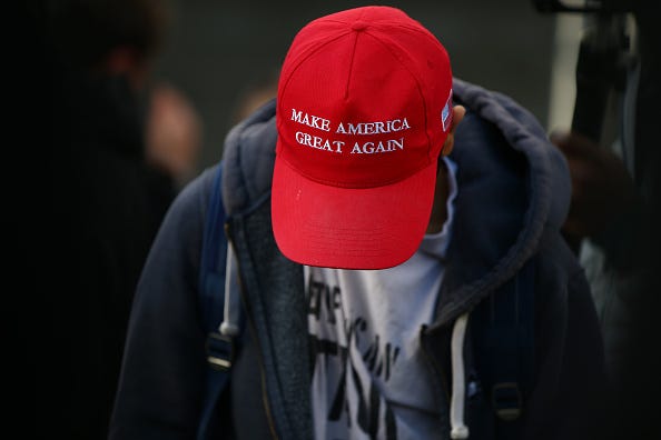 A demonstrator wears a Make America Great Again hat during 'March for Freedom' anti-vaxx protest at Westfield shopping centre in Stratford on December 5, 2020 in London, England. London has been in Tier 2 Covid-19 lockdown restrictions since the nation-wide lockdown ended on December 2.