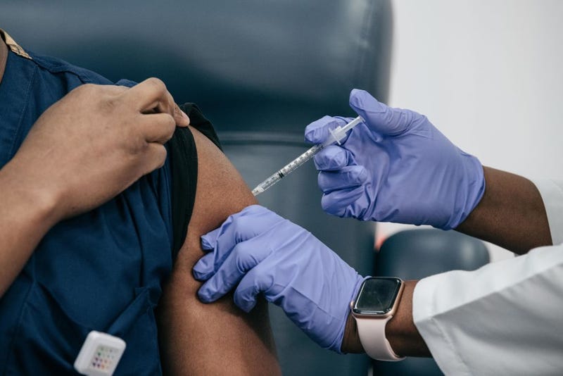 Lenox Hill Hospital Chair of Emergency Medicine Yves Duroseau receives the COVID-19 vaccine from Doctor Michelle Chester at Long Island Jewish Medical Center on December 14, 2020 in New Hyde Park on Long Island, New York.