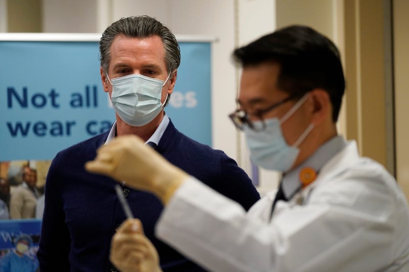 Gov. Gavin Newsom watches as the Pfizer-BioNTech COVID-19 vaccine is prepared by Director of Inpatient Pharmacy David Cheng at Kaiser Permanente Los Angeles Medical Center on December 14, 2020 in Los Angeles, California.