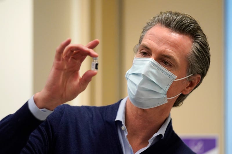 Gov. Gavin Newsom holds up a vial of the Pfizer-BioNTech COVID-19 vaccine at Kaiser Permanente Los Angeles Medical Center on December 14, 2020 in Los Angeles, California. 