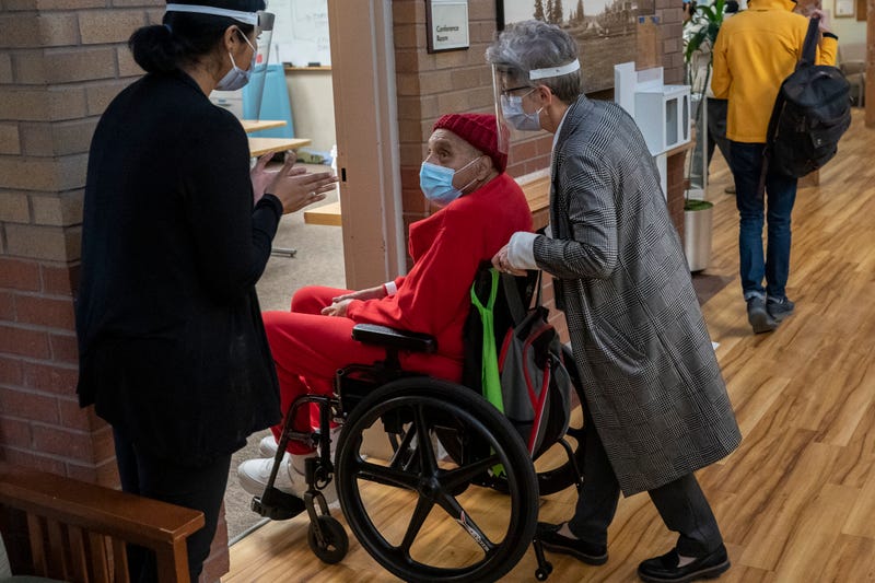 Medical staff applaud before Vietnam War Army veteran James Curry, 78, (R) receives a COVID-19 vaccination at a Veterans Affairs long-term care facility on December 17, 2020 in Vancouver, Washington. Patients in long-term care facilities began receiving the Pfizer-BioNTech COVID-19 vaccine in Oregon this week.