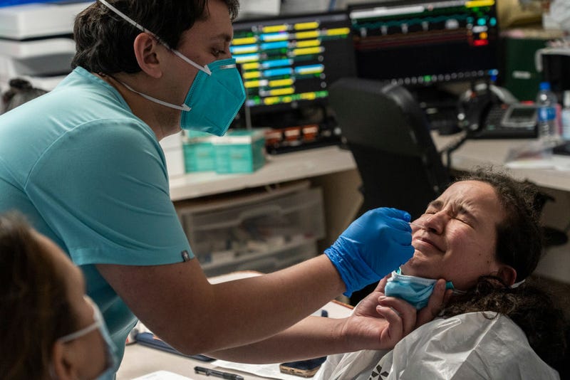 Medical staff administers a COVID-19 test.