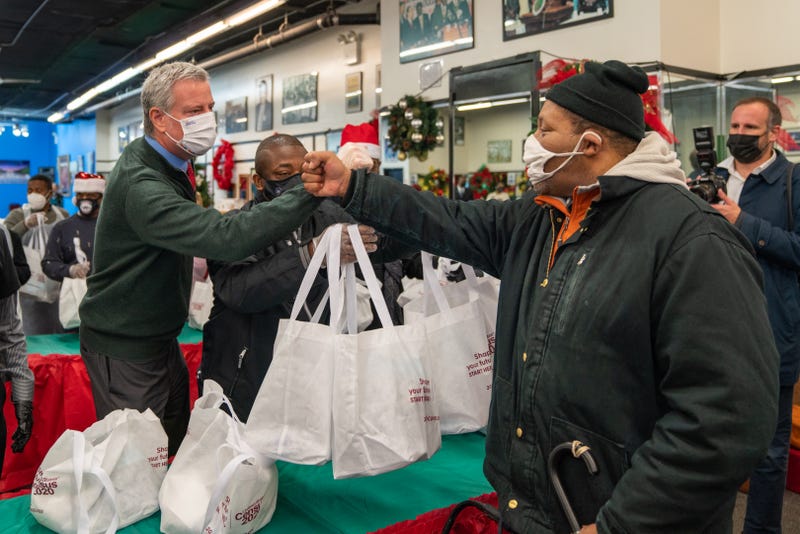 Then-Mayor Bill De Blasio celebrates Christmas by handing out meals the community at the National Action Network's annual event on December 25, 2020 in New York City