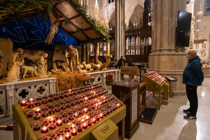 A person reflects at a diorama of the birth of Jesus Christ in St. Patrick's Cathedral on December 25, 2020 in New York City. People are celebrating Christmas during the pandemic as the city reports an increase of nearly 2,900 new cases and a 7 day positivity rate of 6.29%. 