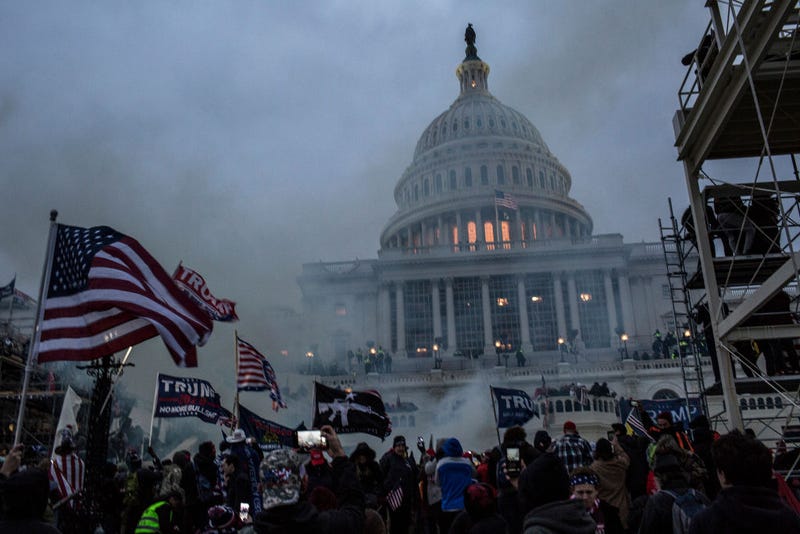 Security forces respond with tear gas after the US President Donald Trump's supporters breached the US Capitol security.