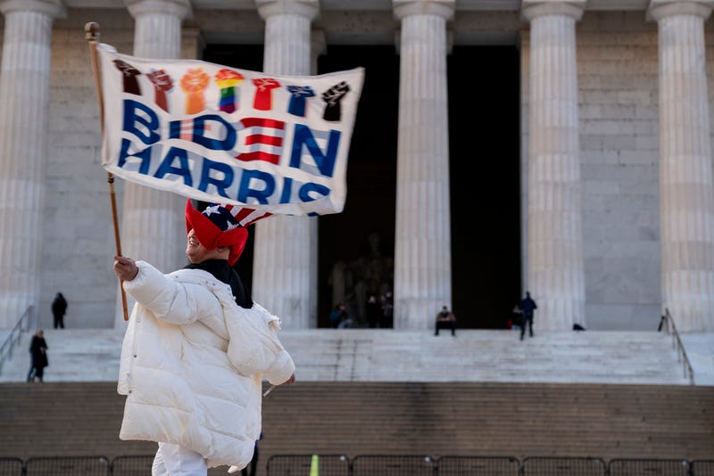 Kyriaki Chris, of Virginia, waves a Biden-Harris flag near the Lincoln Memorial on January 14, 2021 in Washington, DC. Due to security concerns, the National Mall will be closed on Inauguration Day, as people are encouraged to view inaugural events from their home.