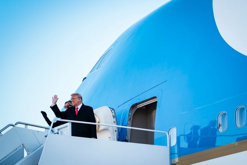 President Donald Trump and first lady Melania Trump wave to supporters as they board Air Force One to head to Florida on January 20, 2021 in Joint Base Andrews, Maryland.