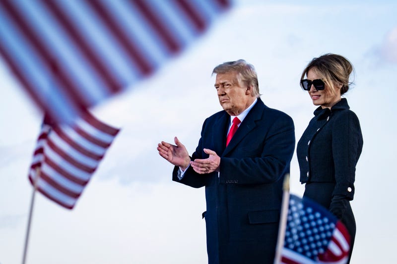 President Donald Trump and First Lady Melania Trump on stage after speaking to supporters at Joint Base Andrews before boarding Air Force One for his last time as President on January 20, 2021 in Joint Base Andrews, Maryland