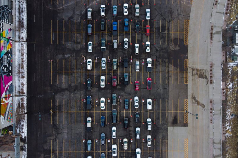 In this aerial view from a drone, cars begin to line up for a mass COVID-19 vaccination event on January 30, 2021 in Denver, Colorado.