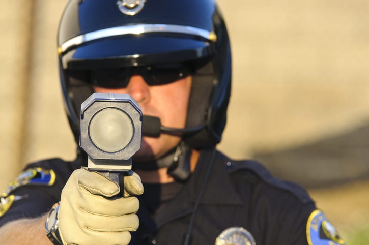 Police officer using speed gun. 