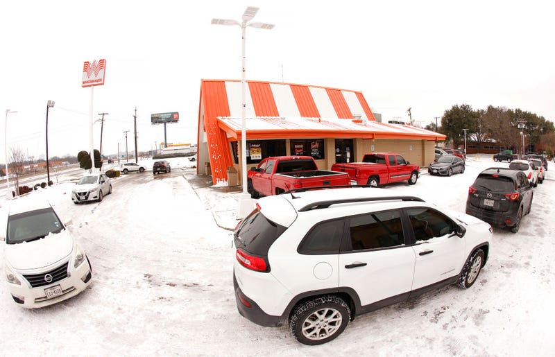  Cars wrap around a Whataburger franchise as they line up to order food after a snow storm on February 17, 2021 in Fort Worth, Texas.