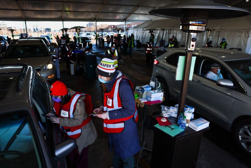 DENVER, CO - FEBRUARY 20: People drive through a tent outside Coors Field as they receive their second dose of the Pfizer-BioNTech COVID-19 vaccine during a mass vaccination event in the parking lot of Coors Field.