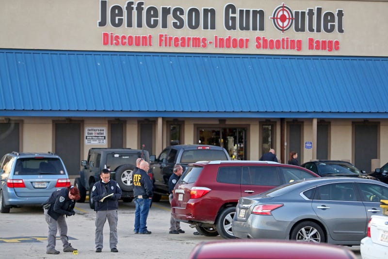 Investigators with the Jefferson Parish Sheriffs Office look at a shell casing in the parking lot of the Jefferson Gun Outlet as investigators work the scene on February 20, 2021 in Metairie, Louisiana. According to reports, three people were killed and two injured after an altercation lead to gunfire at an indoor shooting range. (Photo by Michael DeMocker/Getty Images)