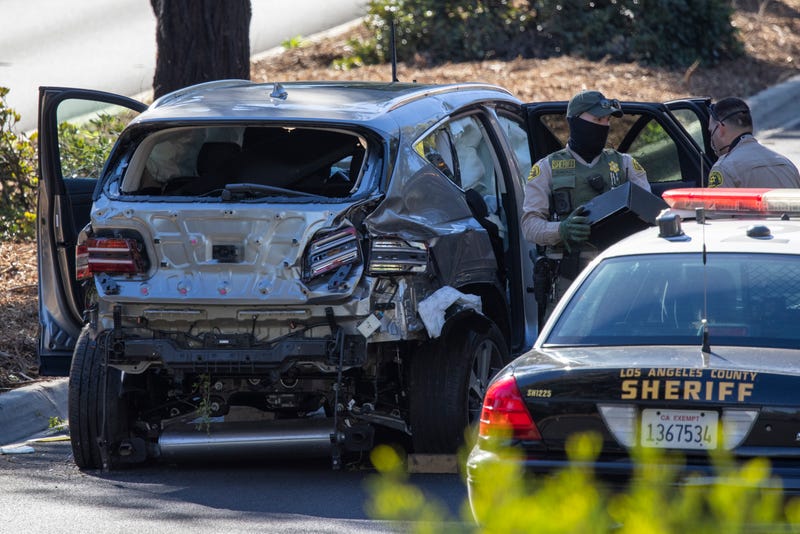 Los Angeles County Sheriff deputies gather evidence from the car that golf legend Tiger Woods was driving when seriously injured in a rollover accident on February 23, 2021 in Rolling Hills Estates, California. Rescuers used hydraulic rescue tools to extricate him from the car where he reportedly sustained major leg injuries. Law enforcement reports that there was no evidence of impairment. He was in town to participate in The Genesis Invitational golf tournament.