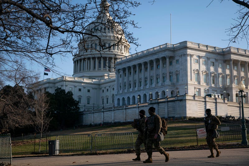 Members of the National Guard walk near the U.S. Capitol on March 4, 2021 in Washington, DC