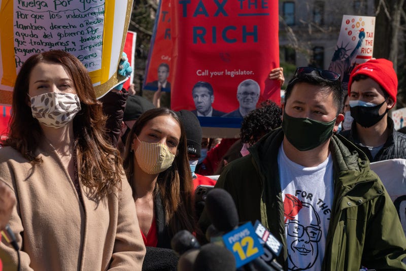 Former New York Governor Andrew Cuomo aide Lindsey Boylan (L), NY Senator Julia Salazar (C) and New York Assemblyman Ron Kim (R) and dozens of protesters gather at Washington Square Park to demand the resignation of the governor on March 20, 2021 in New York City