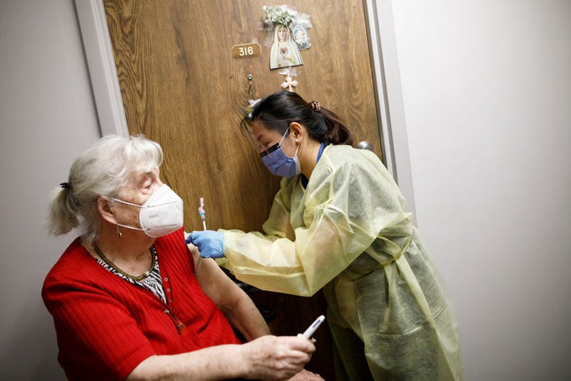 Healthcare workers from Humber River Hospital administer a second dose of the Pfizer COVID-19 vaccination to Sylvana Creglia inside Caboto Terrace, an independent seniors residence, on April 1, 2021 in Toronto, Canada.