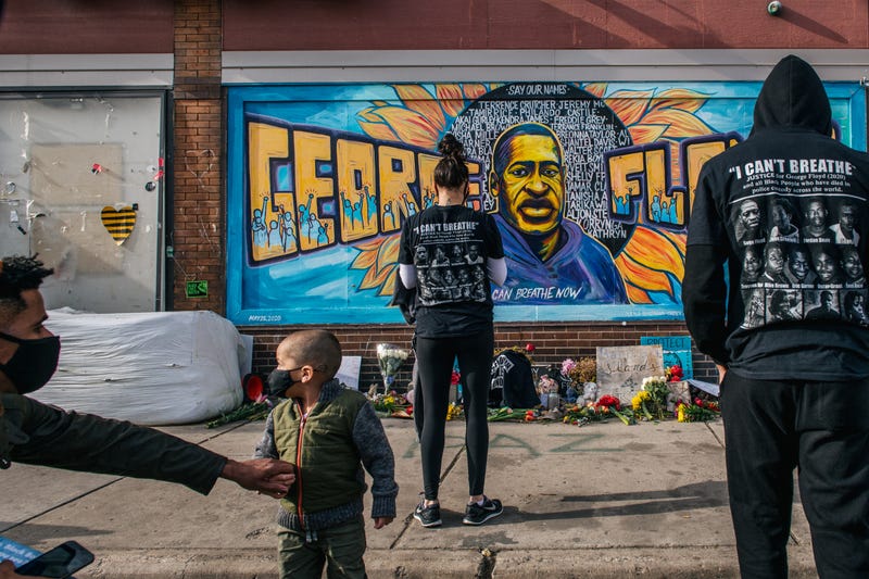 People pay their respects at the mural of George Floyd at the intersection of 38th Street and Chicago Avenue following the verdict in the Derek Chauvin trial on April 20, 2021 in Minneapolis, Minnesota. The former Minneapolis police officer was found guilty on all three charges he faced in the death of George Floyd last May.