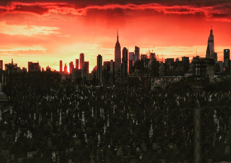The Manhattan skyline is seen behind the tombstones at Calvary Cemetery in Queens last year