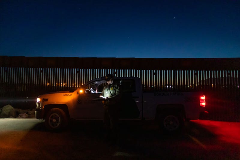 A Border Patrol agent fills out paperwork after he detained an asylum seeker from Haiti at the US-Mexico border on May 12, 2021 in Yuma, Arizona. 