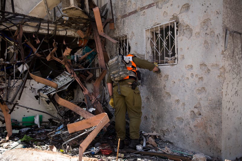 A rescue team soldier checks the site of a rocket strike from the Gaza Strip on May 17, 2021 in Ashdod, Israel. In a press conference on Sunday, Israeli Prime Minister Benjamin Netanyahu said the military assault on Hamas in Gaza will "take time" but acknowledged foreign pressures to reach ceasefire. Sunday was the deadliest day in Gaza during the recent fighting, where officials said 42 people, including 16 women and 10 children, died from Israeli air strikes. In Israel, Hamas rockets hit the southern part of the country, but most were intercepted. According to official figures, nearly 200 people have died in Gaza and 10 have died in Israel since the latest fighting began last week.