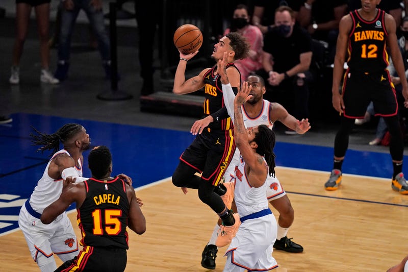 Hawks guard Trae Young drives to the basket for a game-winning shot.