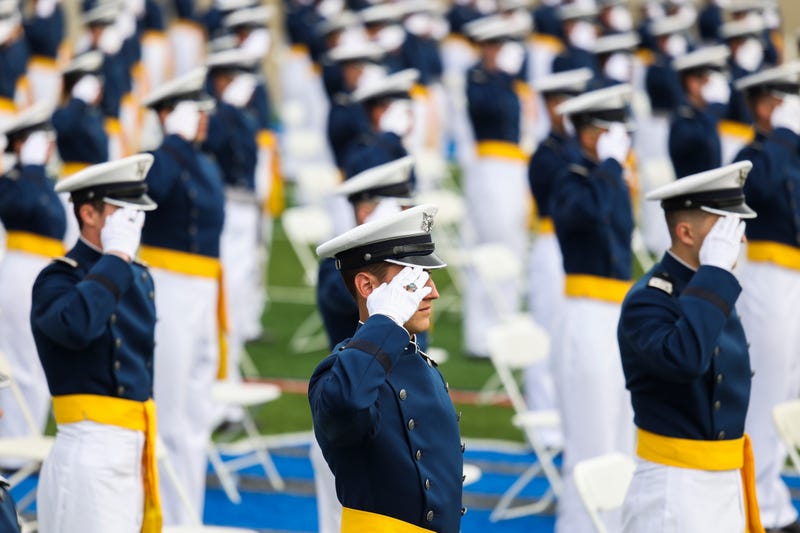 U.S. Air Force Academy graduates salute during a ceremony.