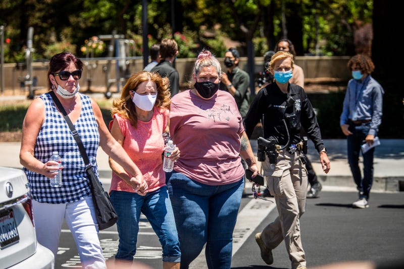 People leave a gathering point for family members and VTA employees on May 26, 2021 in San Jose, California.