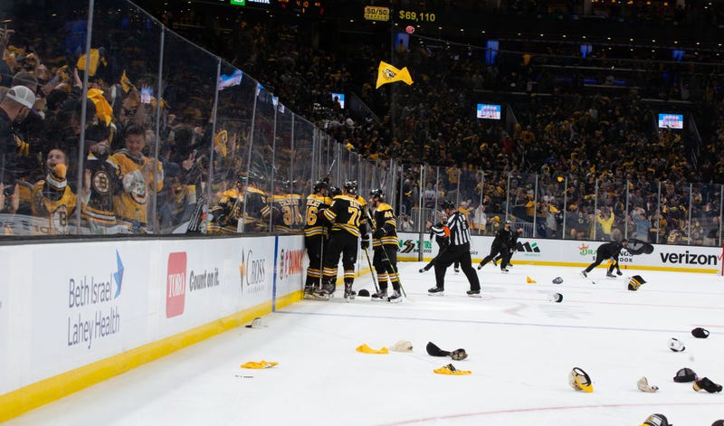 Hats and rally towels rain down on the TD Garden ice after David Pastrnak's hat trick