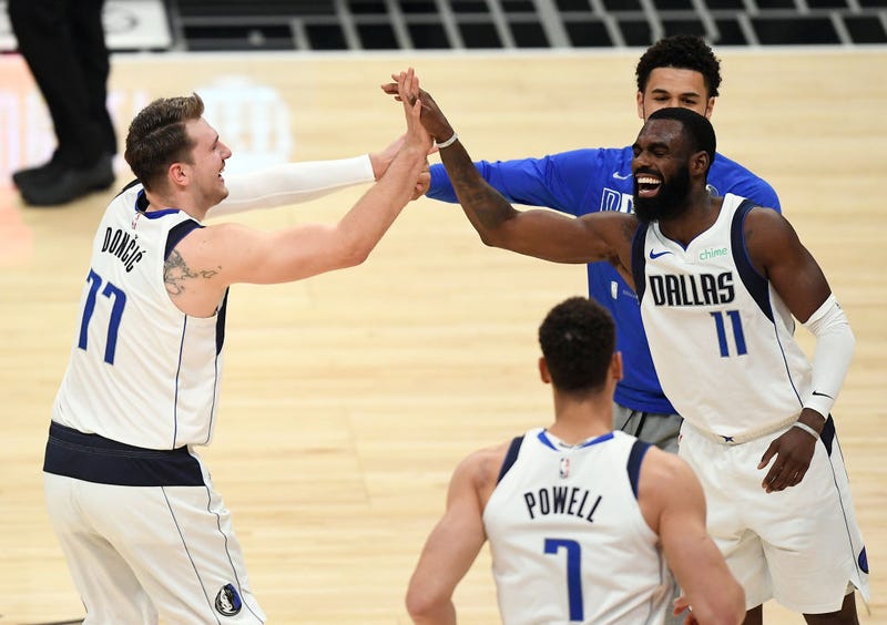 Luka Doncic #77 of the Dallas Mavericks is congratulated by Tim Hardaway Jr. #11 after scoring a basket against Los Angeles Clippers during Game Five of the Western Conference first round series at Staples Center on June 2, 2021 in Los Angeles, California.