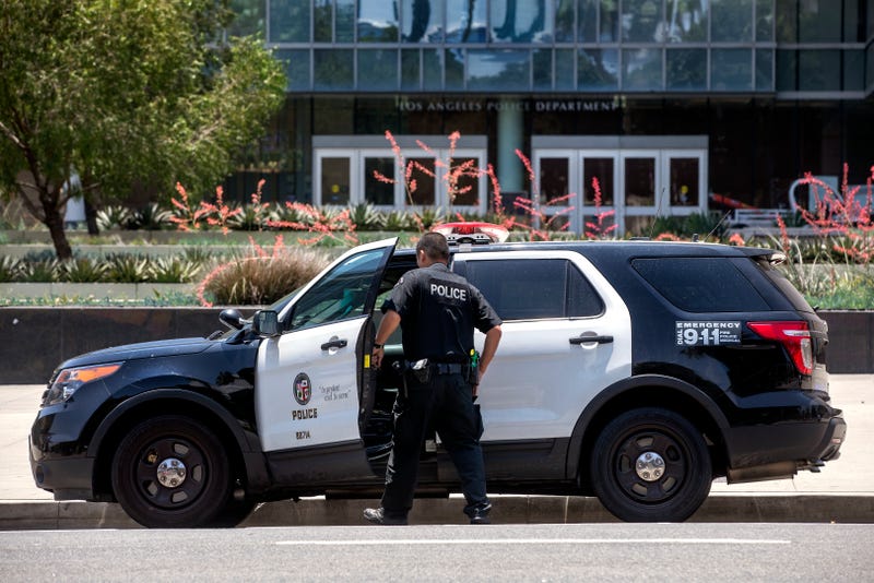 gun on  tableA member of the LAPD gets into his patrol car parked in front of LAPD Headquarters on 1st St. in downtown Los Angeles.