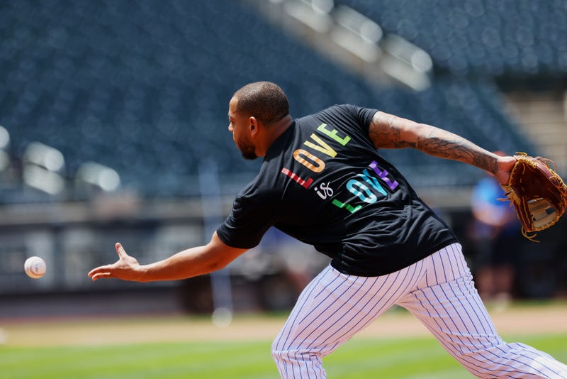 Dominic Smith #2 of the New York Mets warms up with a Love is Love shirt in honor of Pride Night before game one of a doubleheader against the Philadelphia Phillies at Citi Field on June 25, 2021 in New York City.
