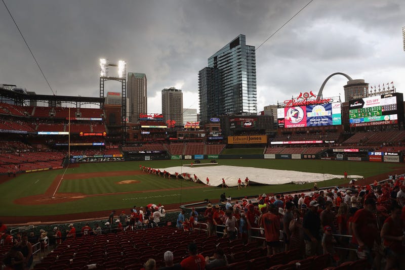 The grounds crew pulls a tarp over the infield prior to a thunderstorm delaying a game between the St. Louis Cardinals and the Pittsburgh Pirates at Busch Stadium on June 27, 2021 in St Louis, Missouri.