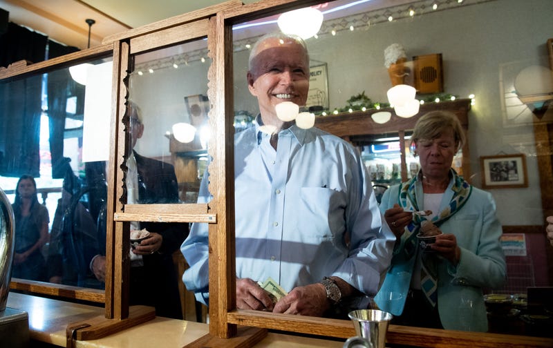 US President Joe Biden orders an ice cream cone while visiting the The Pearl Ice Cream Parlor & Confectionery in La Crosse, Wisconsin, June 29, 2021. - US President Joe Biden stood in an oily, machinery filled warehouse in Wisconsin to tout his multi-trillion dollar infrastructure plans Tuesday, arguing that America needs everything from better bridges to broadband to remain competitive. 
