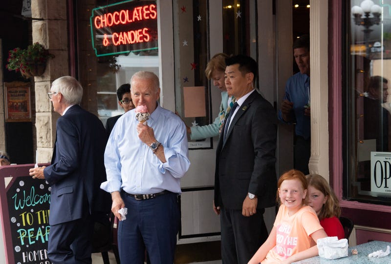 US President Joe Biden eats an ice cream cone while visiting the The Pearl Ice Cream Parlor & Confectionery in La Crosse, Wisconsin, June 29, 2021. 
