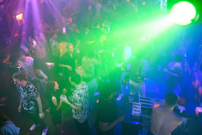 People dance and drink in West Hollywood, California.