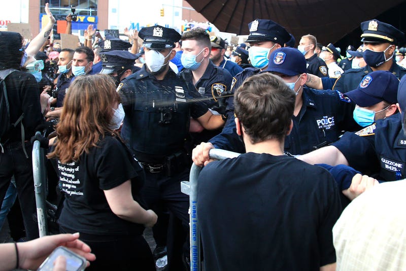 New York Police Department (NYPD) officers spray tear gas during a protest in response to the police killing George Floyd in front of Barclays Center on May 29, 2020 in the Brooklyn borough of New York City. 